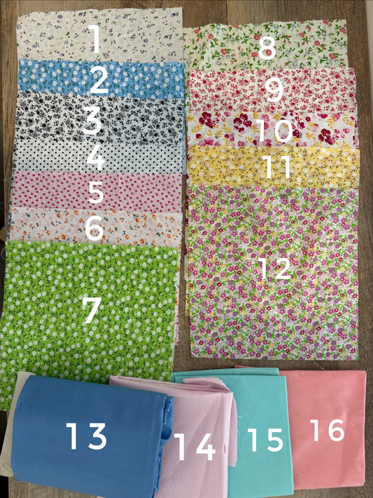 An assortment of floral and pattern fabrics with number labels. 