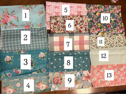 Set of fabric swatches with various patterns and colors on a brown background.