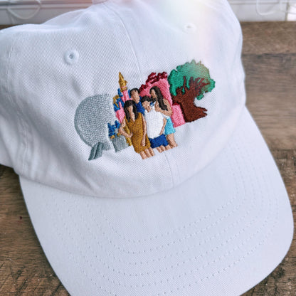White hat with embroidery of 4 park icons and a family. 