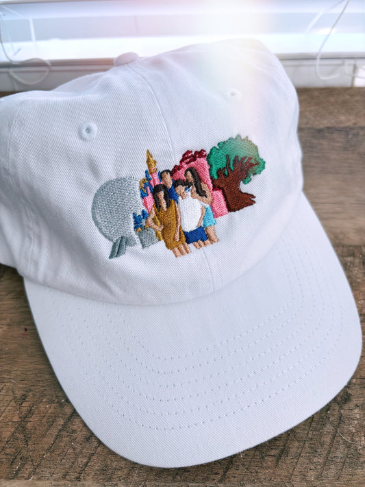 White hat with embroidery of 4 park icons and a family. 
