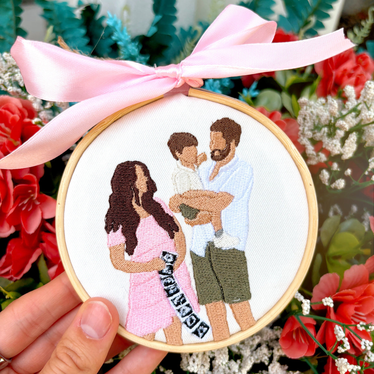 Floral background with a custom embroidered ornament of a family.