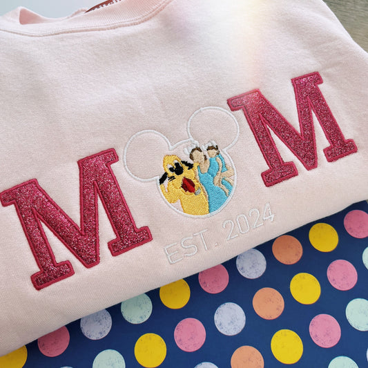 Sweatshirt with 'MOM' and cartoon character design on a polka dot background